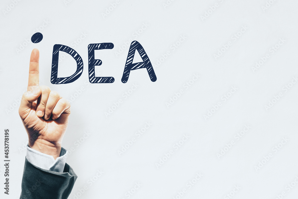 Poster Hand pointing up replacing letter i in idea word on white background with mock up place. Inspiration and creativity concept.