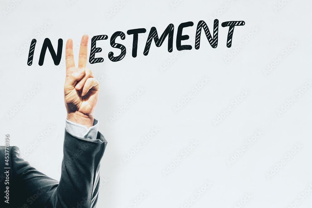 Aufkleber hand with peace sign gesture replacing letter v in investment word on white background with mock up 