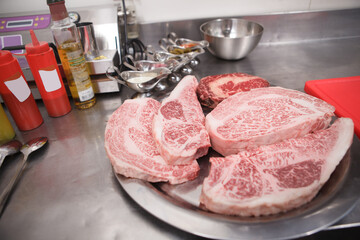 Close up of marbled beef steaks on a plate at restaurant kitchen