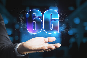 Male hand holding abstract glowing 6G hologram on dark blue background. Internet, technology and communication concept.