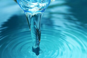 Pouring drinking water from rim bottle close up photo front view copy space 