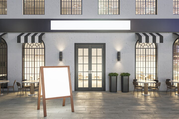 Creative concrete cafe exterior with terrace furniture, blank banner and empty chalkboard menu stand at night. Mock up, 3D Rendering.