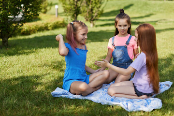 Fototapeta na wymiar cute children girls playing together in the park
