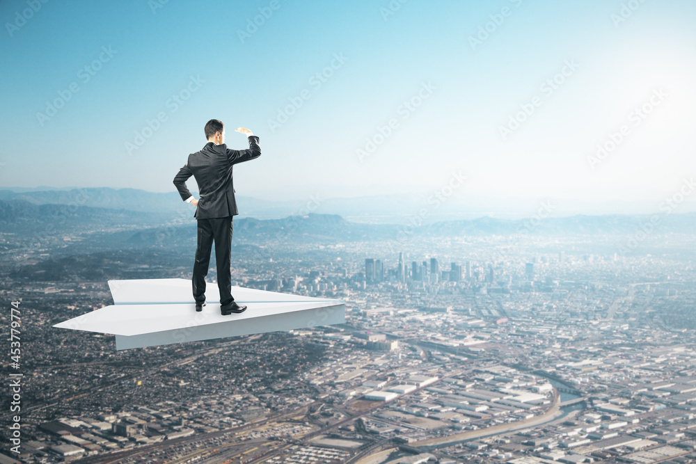 Poster businessman on abstract paper plane looking into the distance on creative bright sky background with