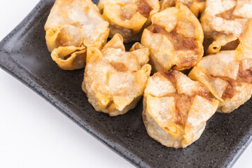 Fried shumai or Chinese dumplings on Black Plate, Food or Cooking Background, Nobody