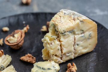 French blue cheese Roquefort, made from sheep milk with walnuts. Food recipe background. Close up