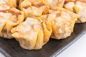Fried shumai or Chinese dumplings on Black Plate, Food or Cooking Background, Nobody