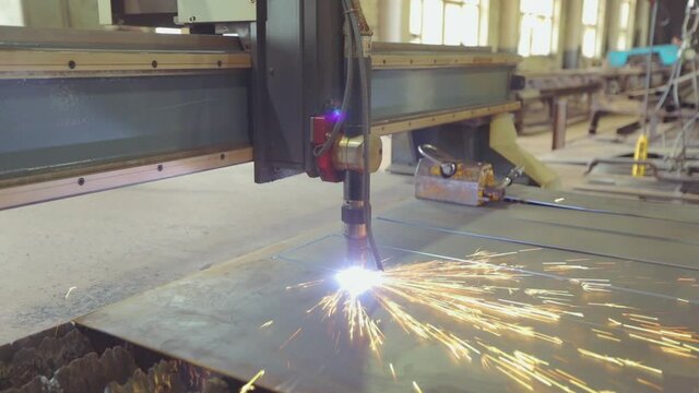 Cutting metal blanks on a CNC machine. Work gas cutting. Gas cutting in a factory.