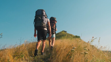 The man and woman hiking with backpacks