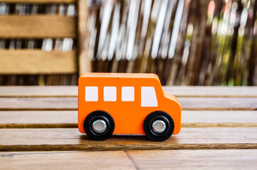 Closeup shot of a wooden orange toy bus