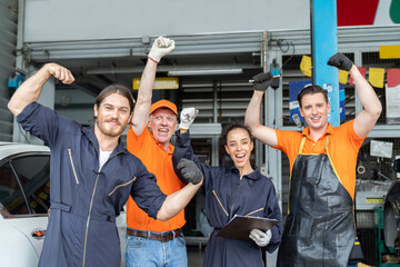 Group of mechanic worker success after worker, service and maintenance in the garage. Diverse male...
