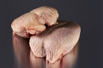 Whole chicken breasts on stainless steel