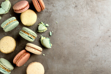 Delicious macarons on grey table, flat lay. Space for text