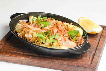 Tuna casserole with pasta and crumbs served in a pot over white background. Fish casserole with grilled veggies