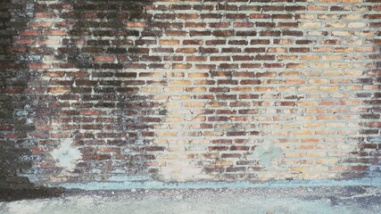 Old brick wall has brown stains and scratches. Abandoned architecture is a terrible thing.