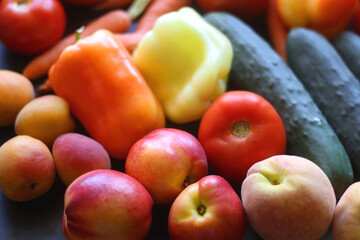 Various colorful summer fruit and vegetable on dark background. Selective focus.