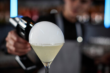 barman is making cocktail with smoky air bubble