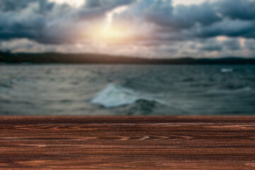Fototapeta na wymiar Wooden table on a dark autumn day on the seashore 