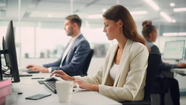 Young Confident Businesswoman Using Desktop Computer in Modern Office with Colleagues. Stylish Beautiful Manager Working on Commercial, Financial and Marketing Projects. Specialist in Diverse Team.