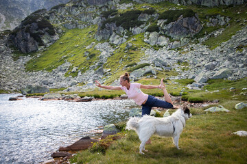 Fototapeta na wymiar healthy young woman doing yoga in mountain landscape by lake
