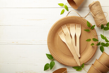 Eco friendly disposable dishes with green leaves on white background. Zero waste, eco friendly,...