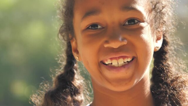 Happy African American girl laughing, smiling face, closeup portrait.