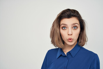 Business woman in blue shirt emotions posing light background