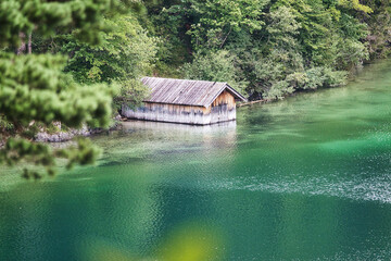 Boats house in the forest on a beautiful green lake