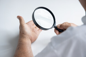 old senior male fortune teller doing palmistry fortune telling, hand closeup shot
