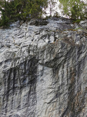 A view from below of the marble section of the Marble Canyon in the Ruskeala Mountain Park on a sunny summer day.