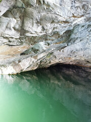 The wall of the grotto, reflected in the emerald water of the Marble Canyon in the Ruskeala Mountain Park.