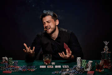 Bearded casino player man playing poker on green table