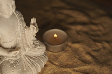 A candle accompanying the buddha meditation.