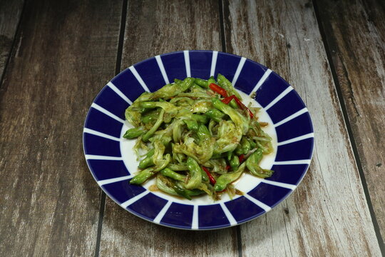 Traditional fried fresh Agasta flower with chilly serving on the plate. Famous vegetarian menu in Asia restaurant. 