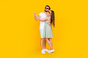 Photo of charming couple disco party dance hug wear sunglass casual outfit isolated yellow color background