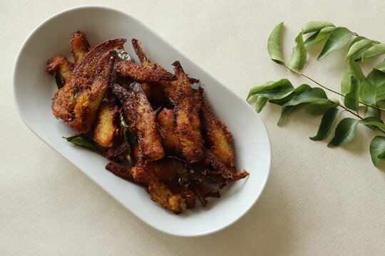 Crispy and spicy Anchovy fry. Anchovies marinated with spices and deep fried. Popular fish dish from Kerala called Natholi fry.