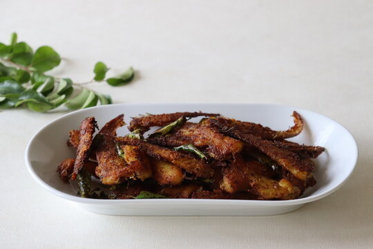 Crispy and spicy Anchovy fry. Anchovies marinated with spices and deep fried. Popular fish dish from Kerala called Natholi fry.