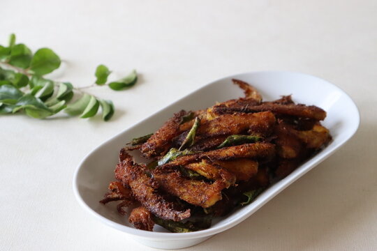 Crispy and spicy Anchovy fry. Anchovies marinated with spices and deep fried. Popular fish dish from Kerala called Natholi fry.