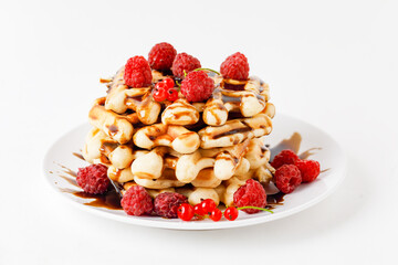 Stack Of Belgium Waffles With Fresh Raspberries And Chocolate Sauce. 
