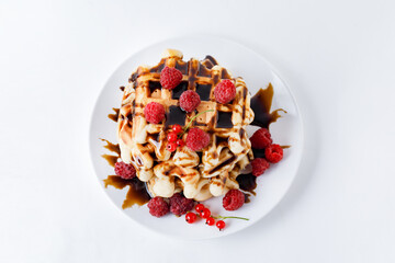 Stack Of Belgium Waffles With Chocolate Syrup And Fresh Raspberries On White Background. Flat Lay.