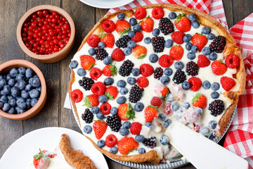Cutter Berries Tart With Cream On Napkin On Wooden Table. Flat Lay. 