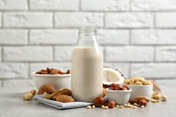 Vegan milk and different nuts on light table