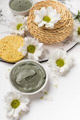 Obraz na płótnie Canvas Natural clay mask dry and wet with flowers on a white background