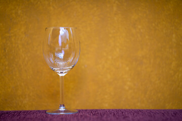 Wine glass on yellow background