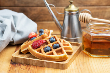 Waffles with addition of fresh blueberries and honey