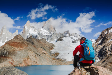 Active hiker hiking, enjoying the view, looking at Patagonia mountain landscape. mountaineering sport lifestyle concept