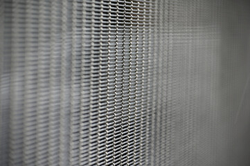 A fine structured metal grid, partial blurred.