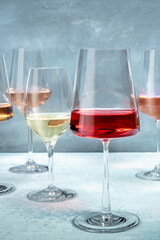Rose wine at a tasting at a winery in an elegant modern glass. Winetasing event