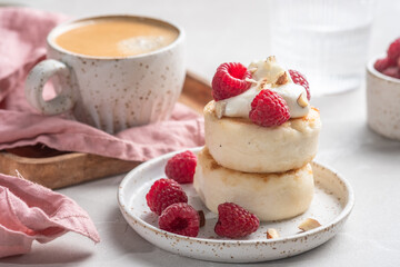Cottage cheese pancakes or syrniki with raspberry and sour cream. Russian, Ukrainian cuisine. Healthy tasty breakfast