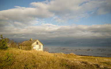 An old, abandoned wooden house by the sea.